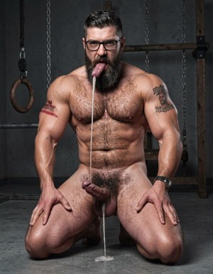 Hyperrealistic cinematic photograph, full body side view, perfect anatomy and proportions, zero distortions or deformations. Dark brutal dungeon gym with concrete floor, hanging chains, wooden stocks and BDSM equipment visible in the shadowed background. Dramatic side lighting, high contrast, deep shadows, realistic sweat and thick saliva strands.

Hipsterbarba, 40 years old, 180cm, 80kg, 8% body fat, stands dominant and completely naked on the left. Powerful muscle bear physique covered in dense dark body hair across his chest, shoulders, abs and thick thighs. Long thick Bandholz beard reaching almost to his chest, curled handlebar mustache, black glasses, cold and superior expression as he looks down at his slave.

Anil, 25 years old, extreme bodybuilder slave, 175cm, 80kg, 6% body fat, kneels directly in front of him on all fours like an animal. Completely smooth tanned skin from the neck down, massive 127cm chest hanging down, eight-pack abs, 47cm veiny arms, tiny 60cm waist, round 90cm glutes pushed back high, and 70cm quads. Tattoo 